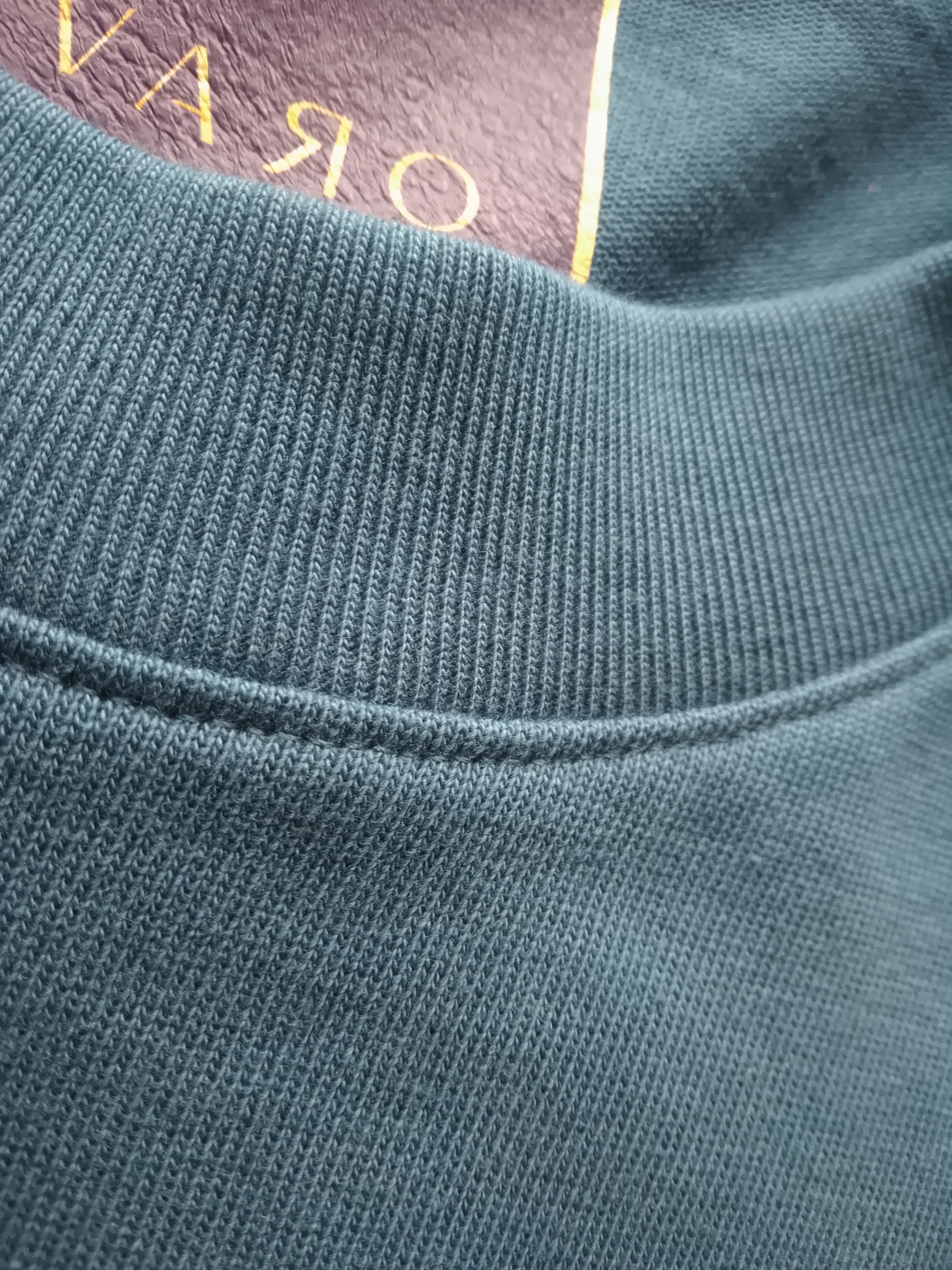 Close-up of a textured fabric edge with a brand name partially visible.