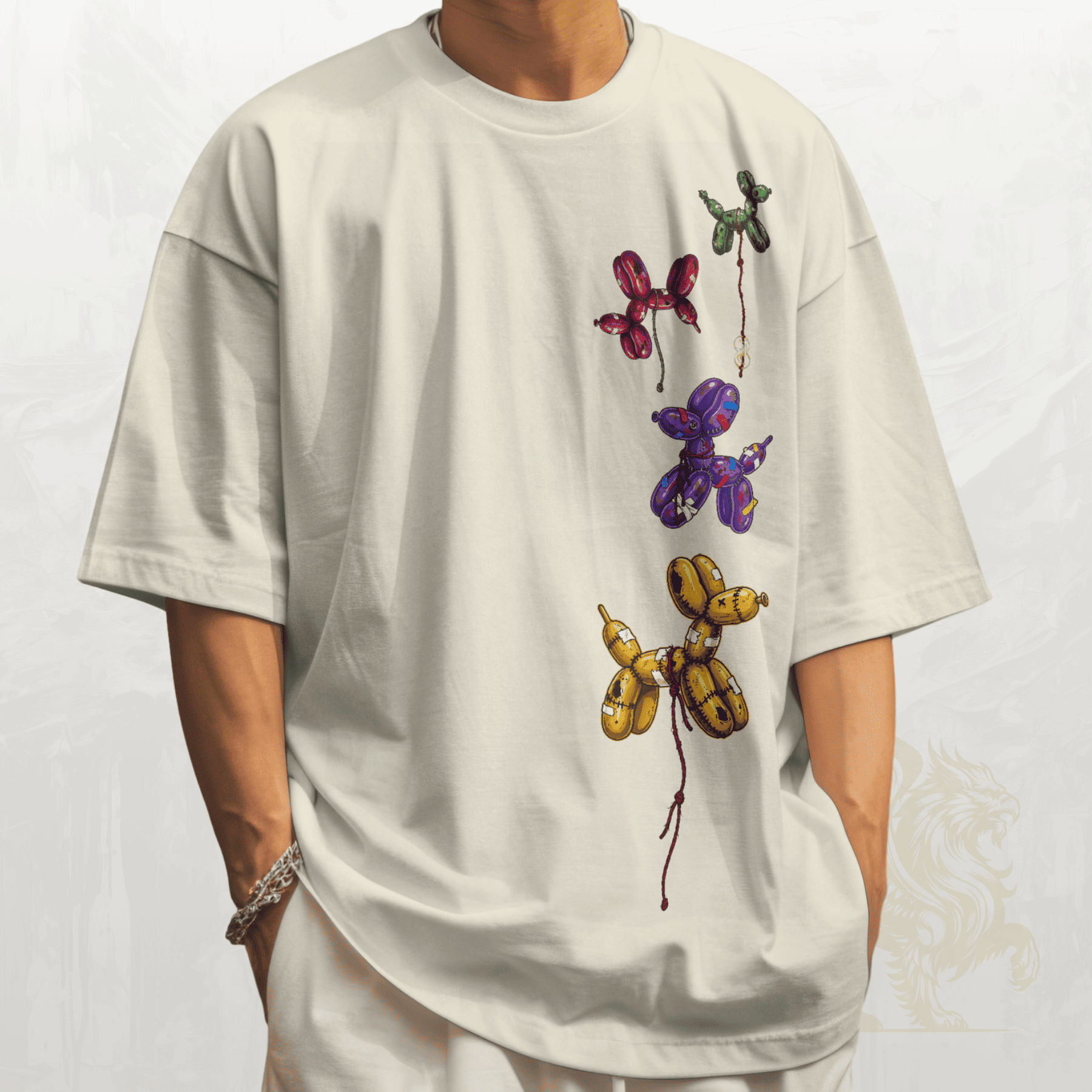 White t-shirt with colorful balloon animal designs on a plain background