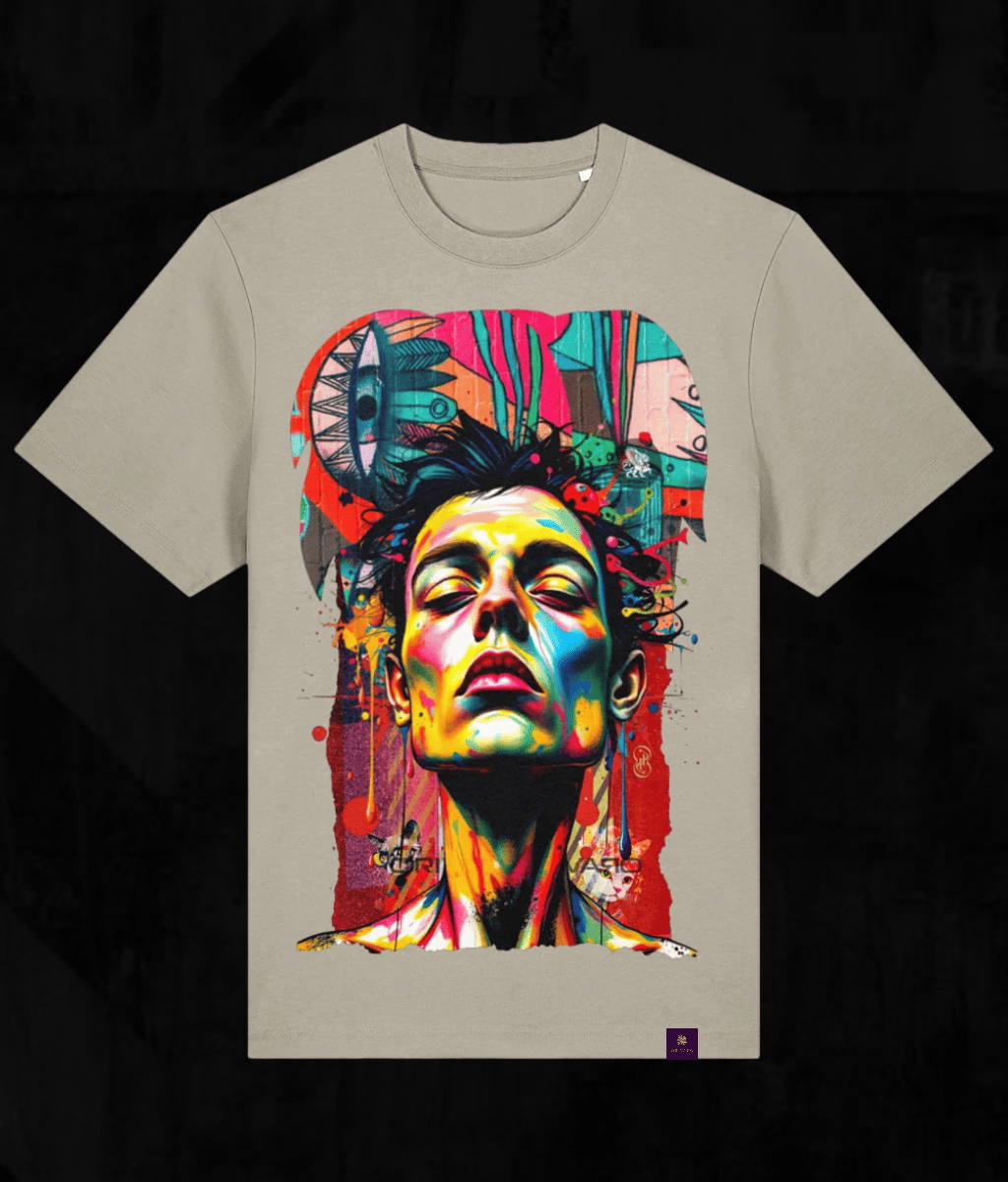 A light beige crewneck t-shirt featuring a large, vibrant graphic print of a stylized face with colourful paint splatters and artistic details, set against a dark background.