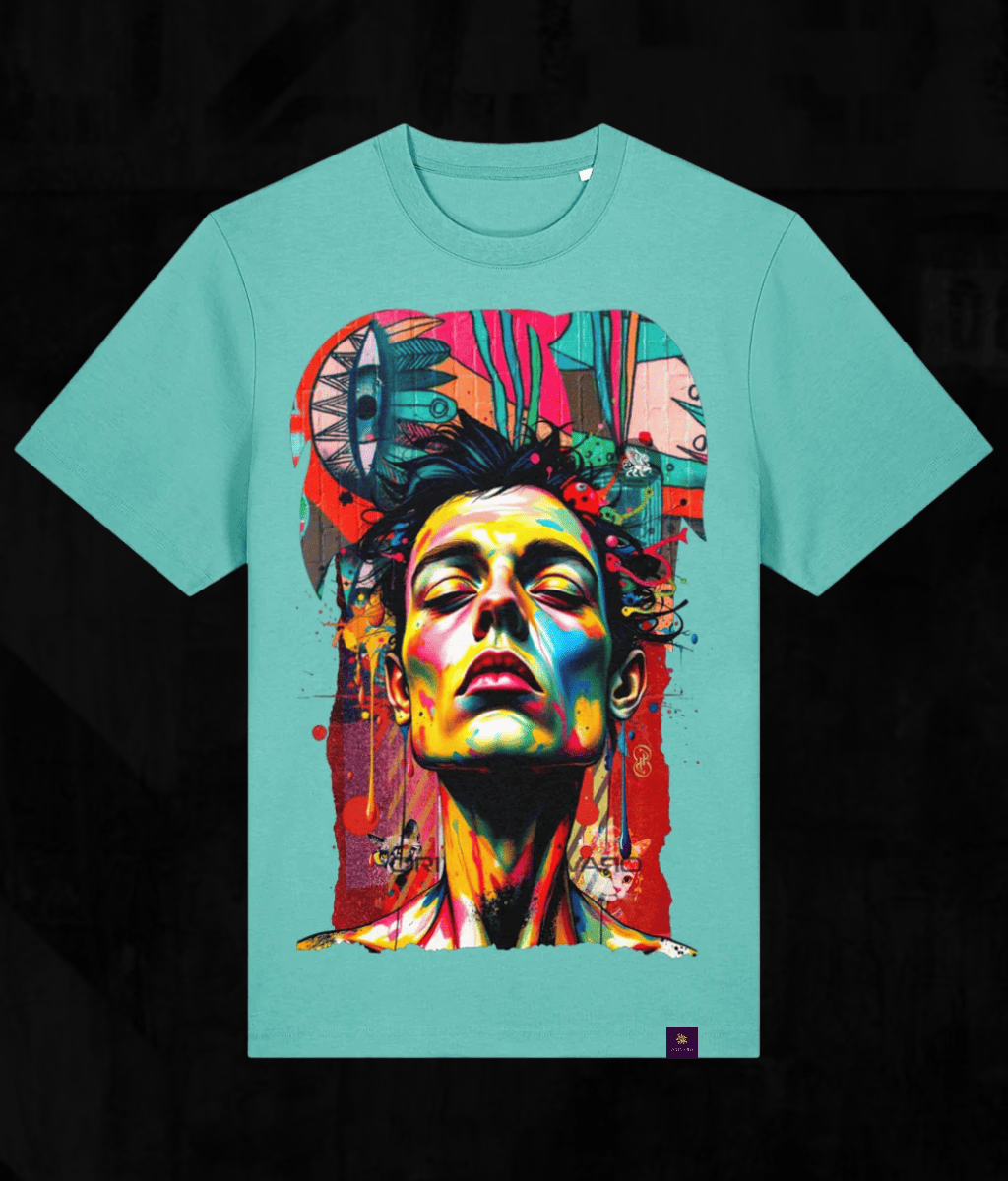 A turquoise crewneck t-shirt featuring a large, vibrant pop-art graphic print of a face with colourful paint splatters and abstract shapes on the front, set against a dark textured background.