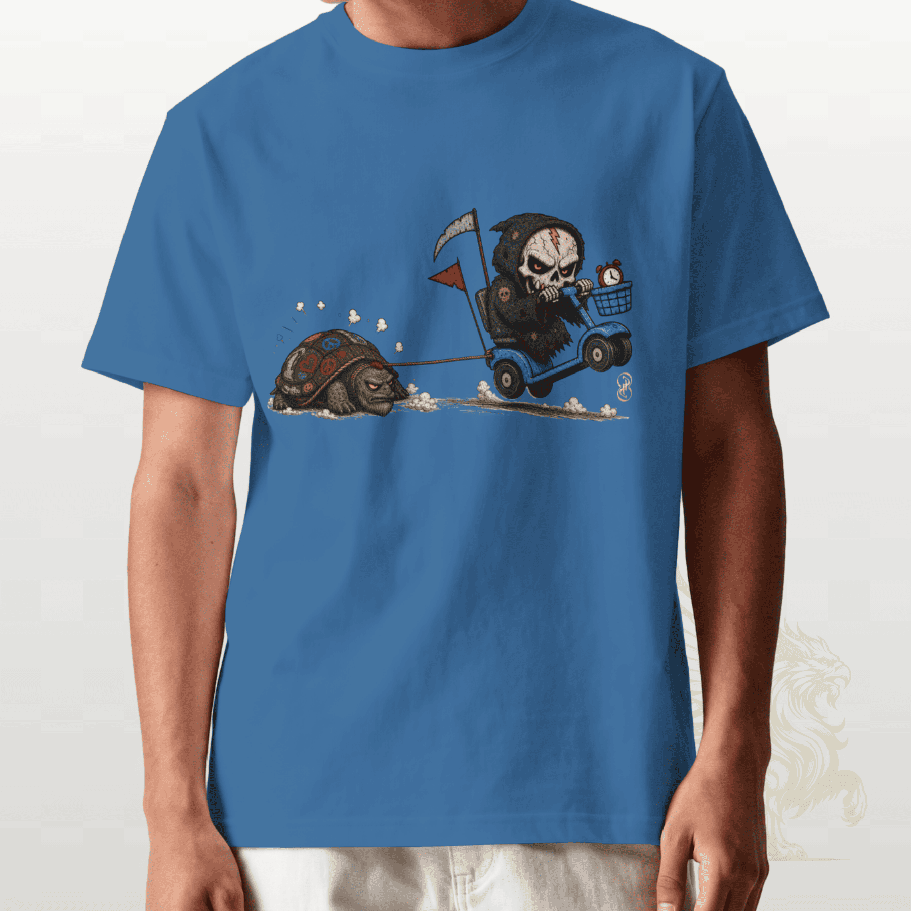 Blue t-shirt with a graphic design of a skull on a motorcycle chasing a tortoise.