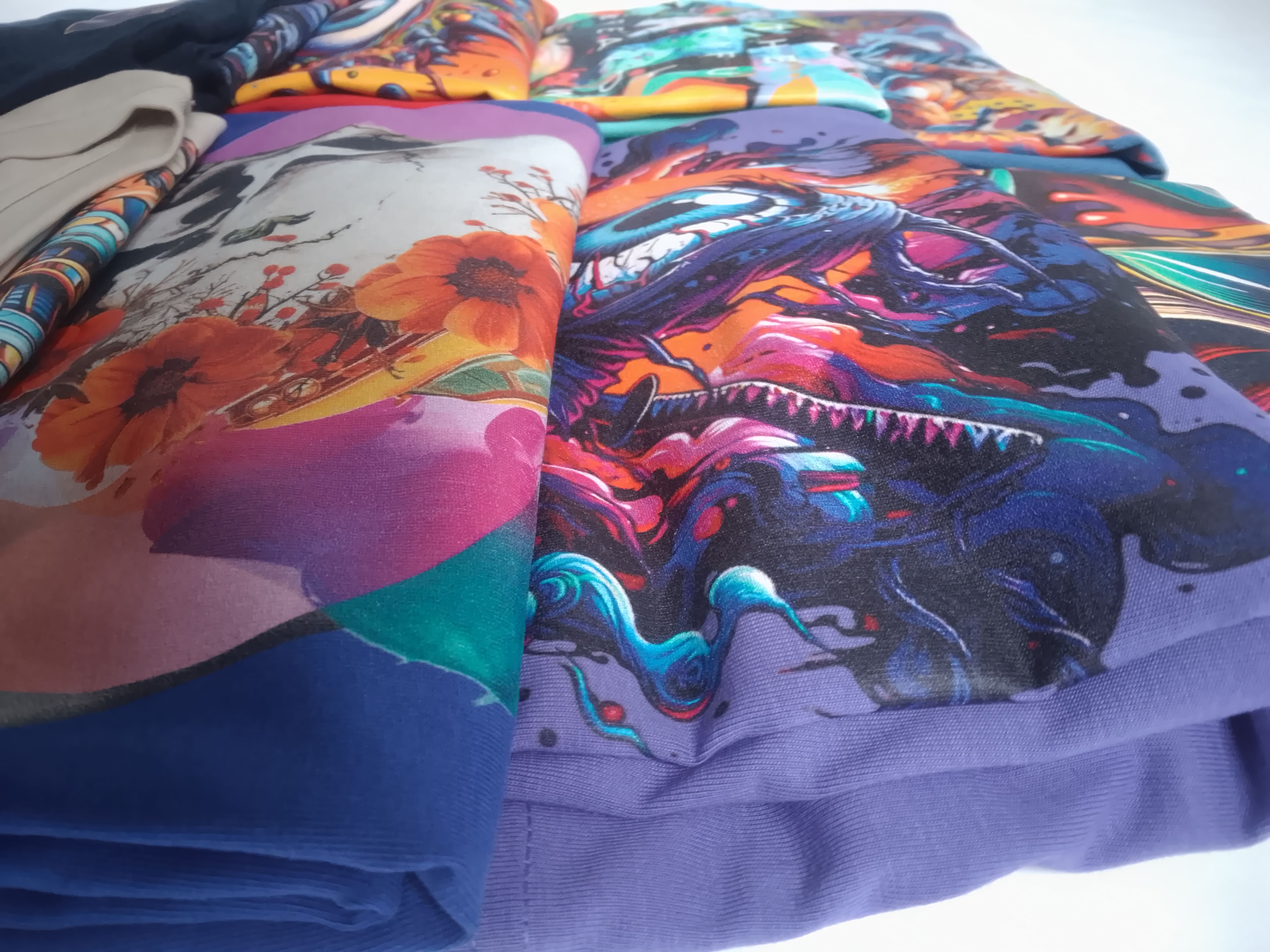 Colourful fabric with abstract designs of a dragon and flowers.