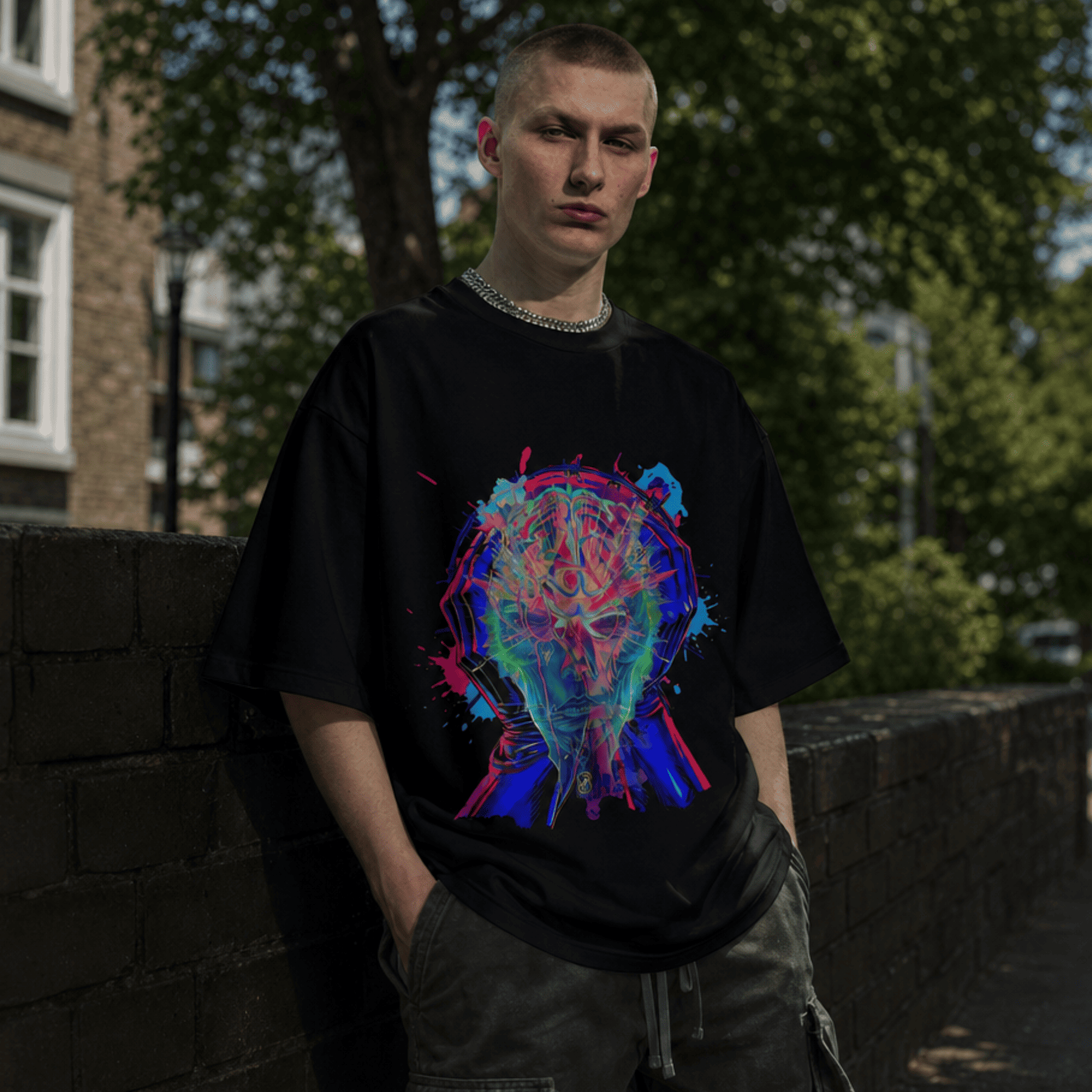 Person wearing a black t-shirt with a colorful graphic design, standing outdoors.
