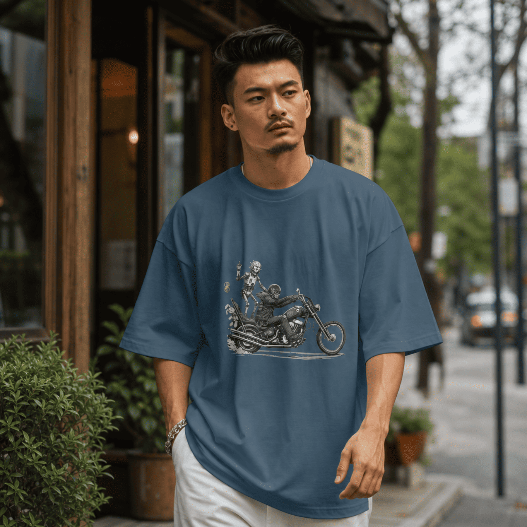 Man wearing a blue t-shirt with a graphic design on a city street