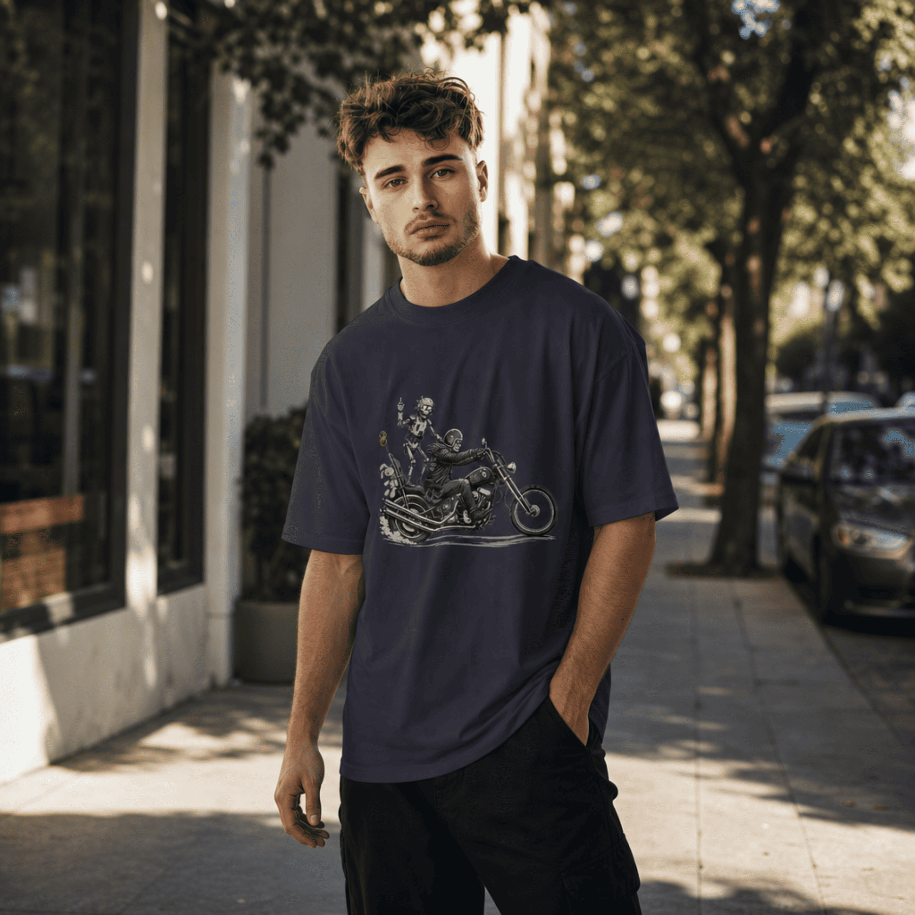 Man wearing a navy blue t-shirt with a graphic design on a city street.