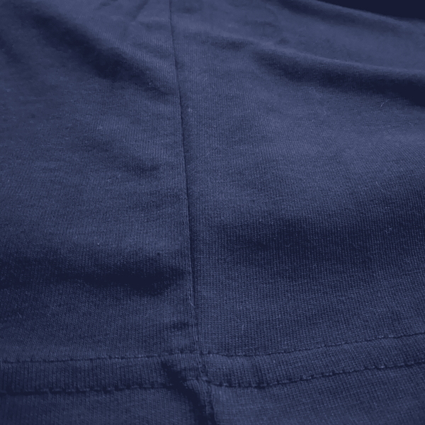 Close-up of a dark navy blue ribbed knit fabric with a visible vertical seam and horizontal stitching.