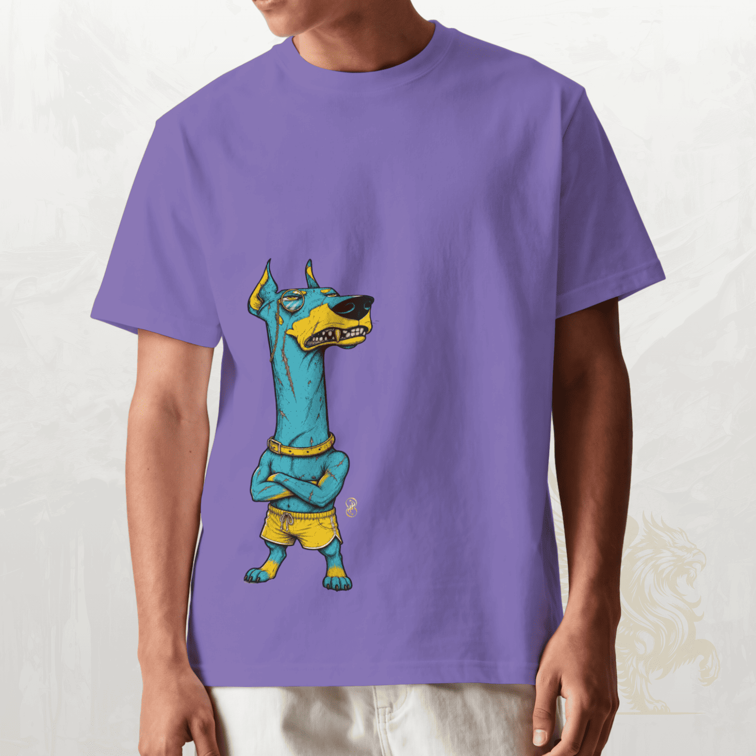 A person wearing a purple short-sleeve crewneck t-shirt with a graphic of a stylized blue and yellow dog character, shown from the neck down against a light textured background.