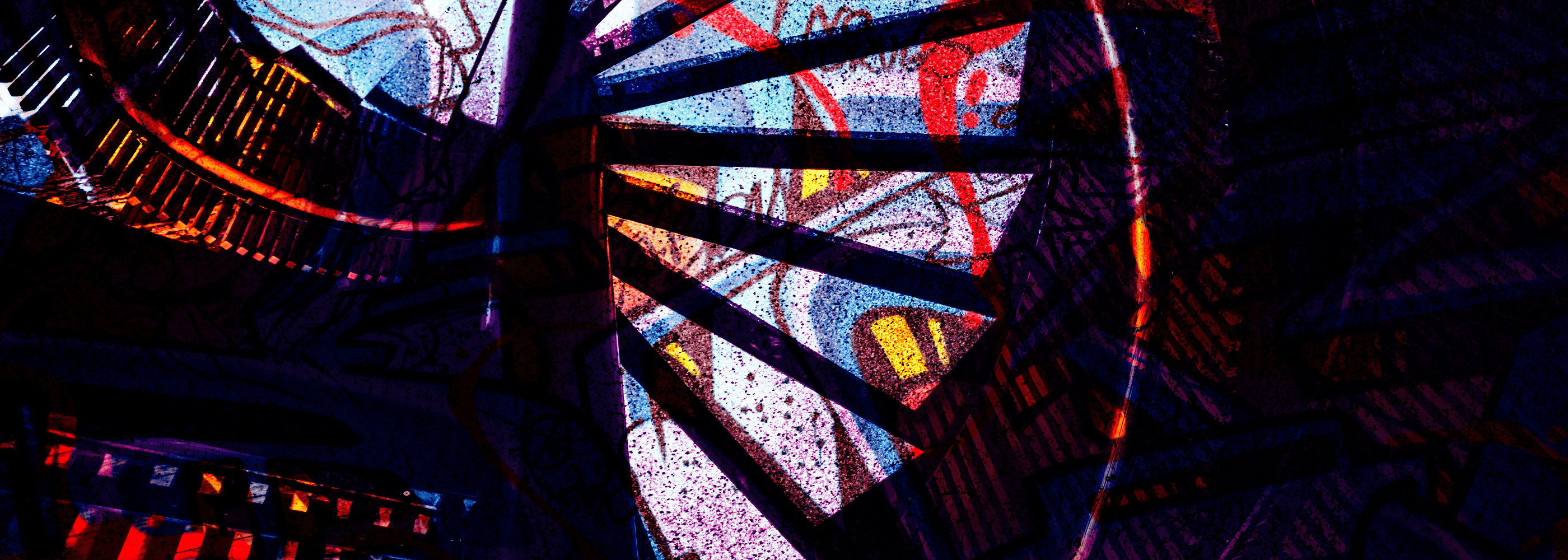 Colorful stained glass window with abstract patterns in a dark setting