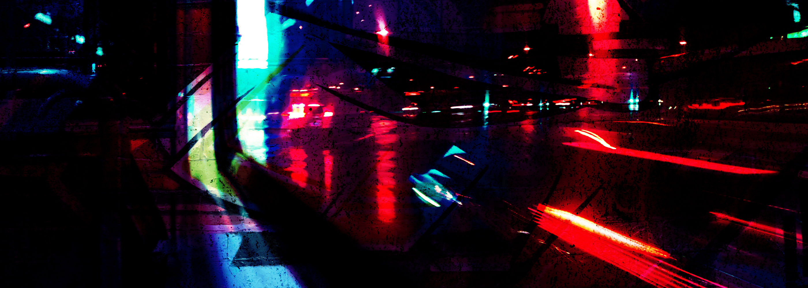 Neon lights reflecting on a wet street at night