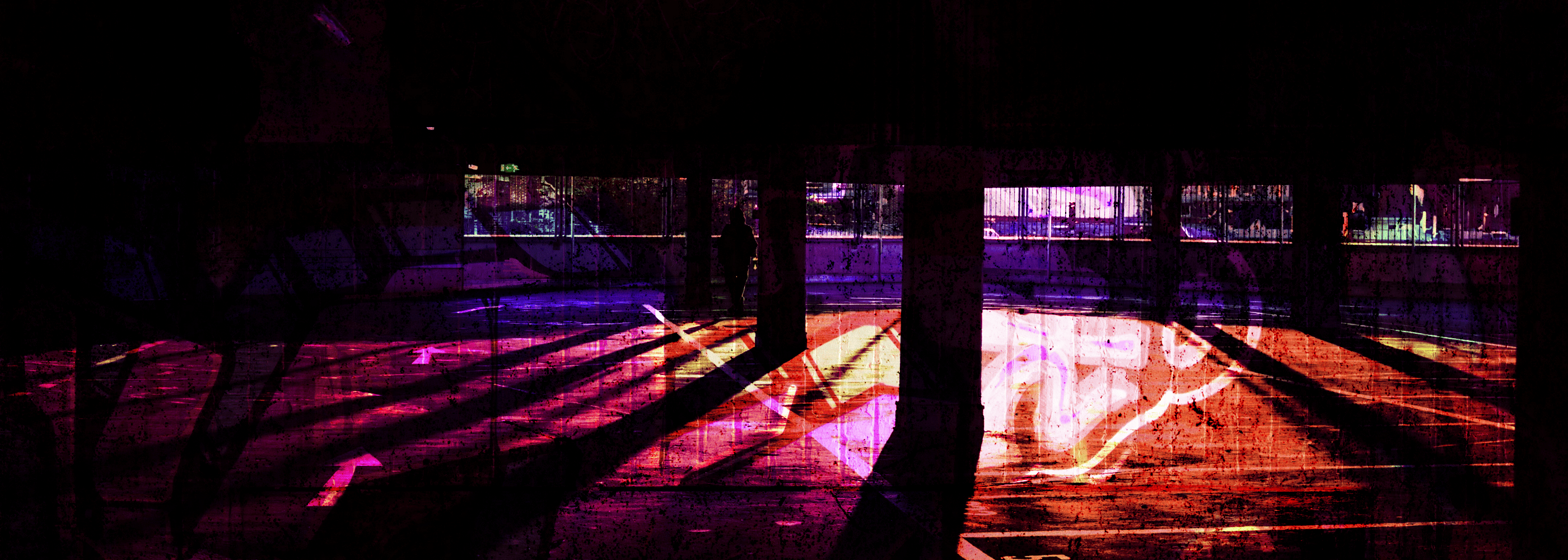 Person standing on a wooden platform with colorful light reflections at night