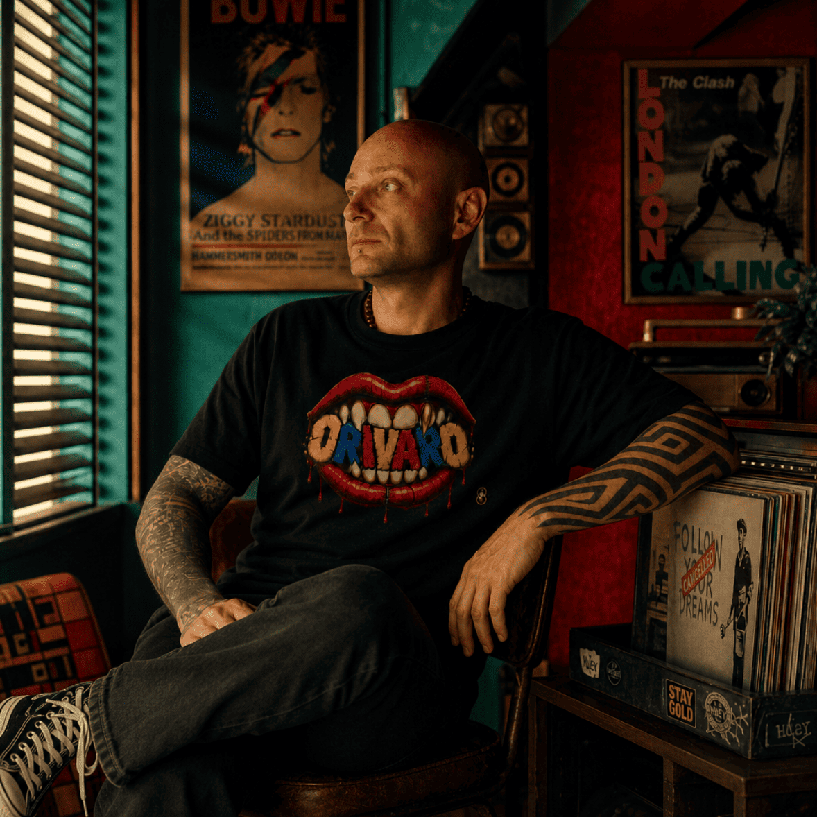 Man sitting in a room with music-themed decor, including posters and vinyl records.